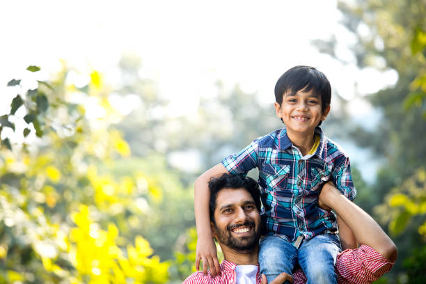 istock Father carrying son on shoulder at park 1292573040