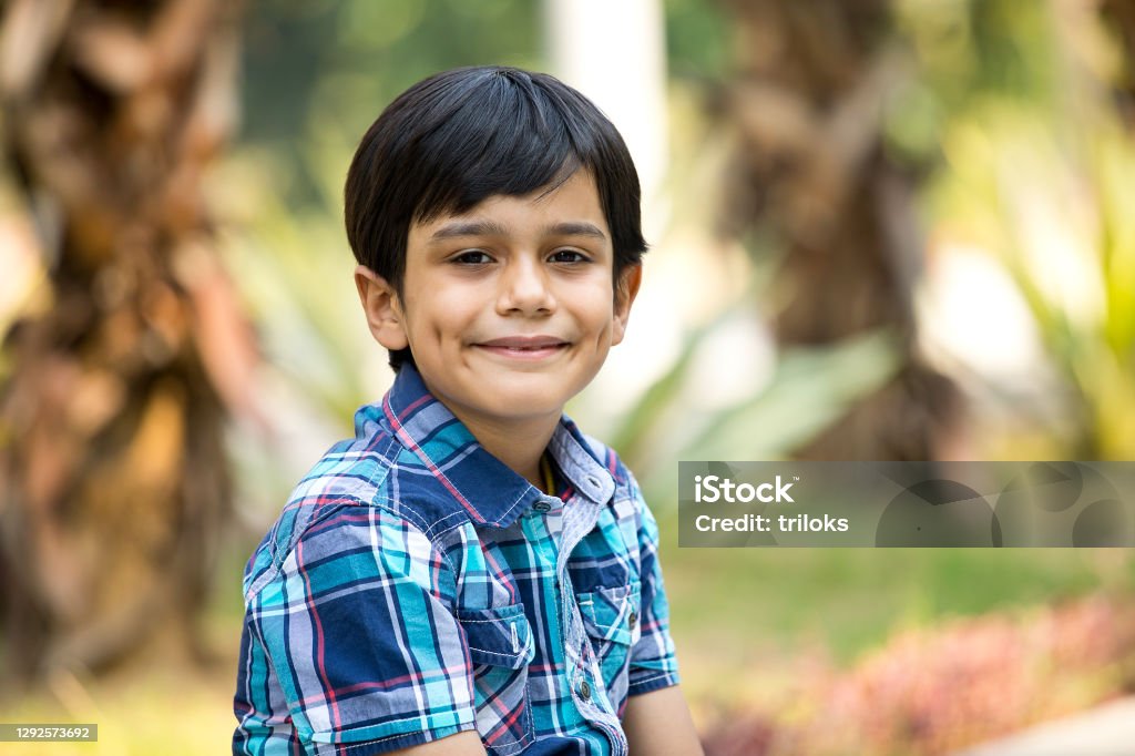 Happy boy looking at camera at park Boys Stock Photo