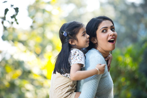 istock Mother and daughter having fun at the park 1292573711