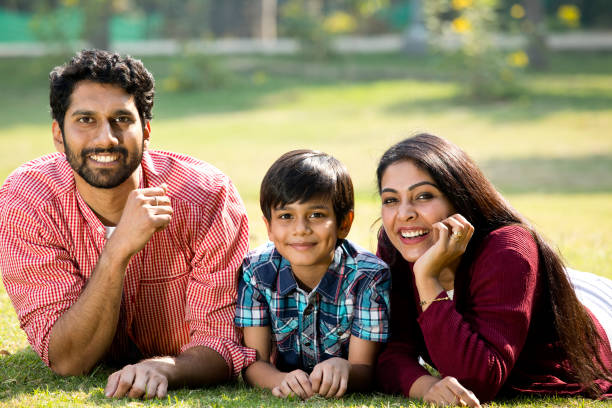 istock Happy boy enjoying weekend with parents at park 1292573723