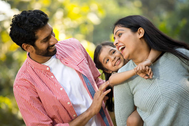 istock Happy mother with father spending time with daughter at park 1292573888