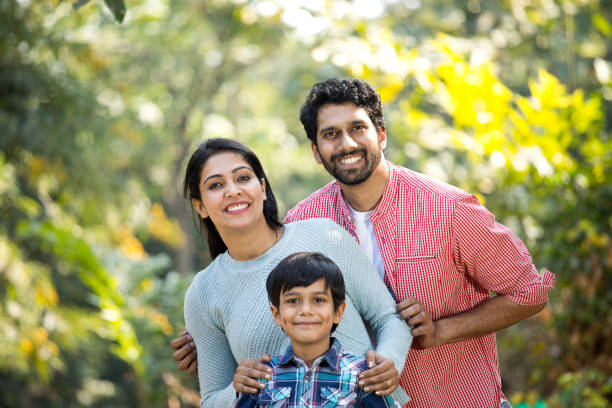 istock Happy Indian family having fun at park 1292574042