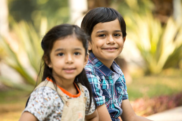 istock Happy brother and sister at park 1292574353