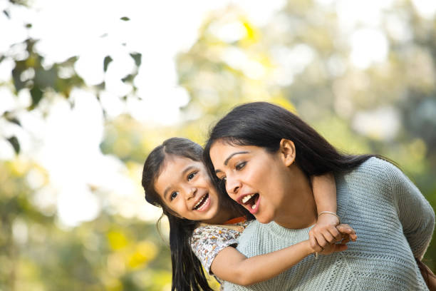 istock Mother and daughter having fun at the park 1292575156