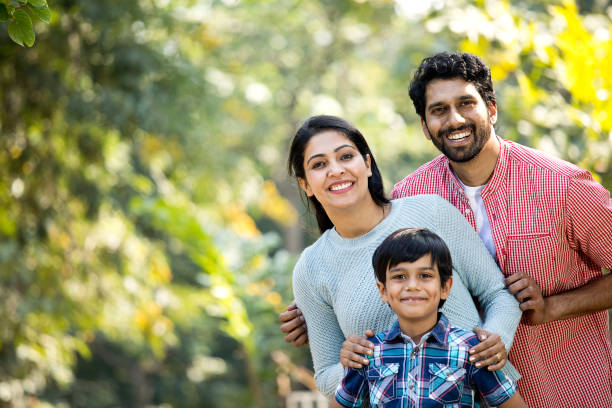 istock Happy Indian family having fun at park 1292575301