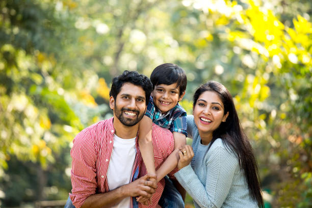 Loving parent and son spending leisure time at park Loving parent and son spending leisure time at park happy indian young family couple stock pictures, royalty-free photos & images