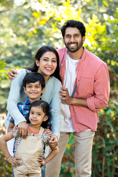 Happy Indian family having fun at park Happy Indian family spending leisure time at park happy indian young family couple stock pictures, royalty-free photos & images