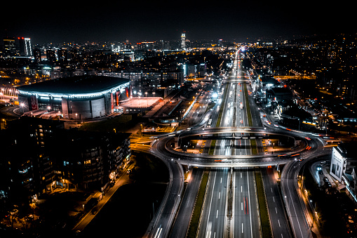 Aerial view of the crossroad intersection in the city during the night with all the street lights.