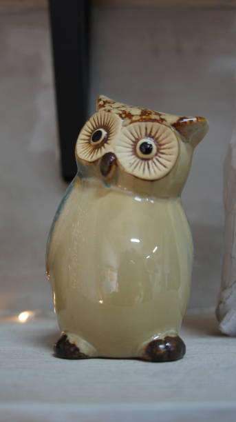 istock Ceramic owl on the shelf, decorative souvenir 1292578801