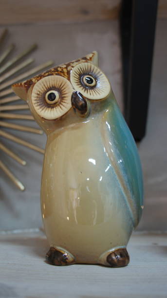 istock Ceramic owl on the shelf, decorative souvenir 1292579382