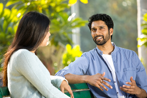 Indian couple talking and spending leisure time at park