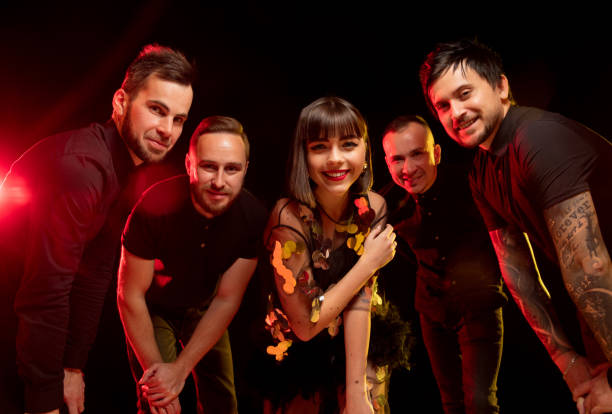 istock Musician's band isolated on dark studio background in neon light 1292580471
