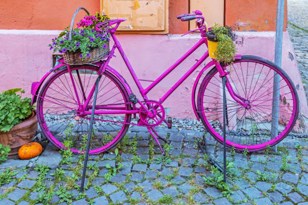 istock Decorative bicycle with flowers on street 1292581440