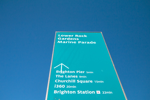 A sign pointing to Lower Rock Gardens on Marine Parade in Brighton, England. There are also named commercial places such as i360