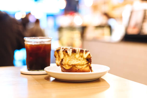 A plate of mini cinnamon rolls and a cup of black coffee