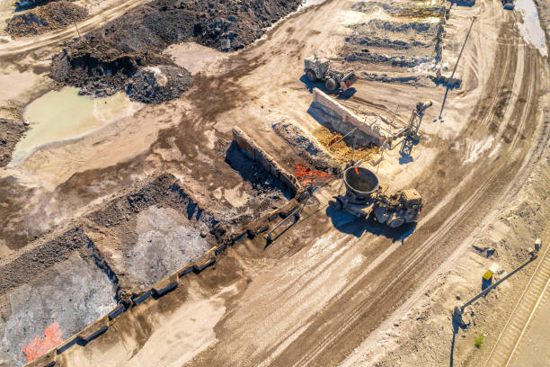 Aerial Overhead View of Mining Operations and Equipment and Metal Processing Facility. Aerial Overhead View of Mining Operations and Equipment. Cranes, Conveyors, ore and mineral. slag heap stock pictures, royalty-free photos & images