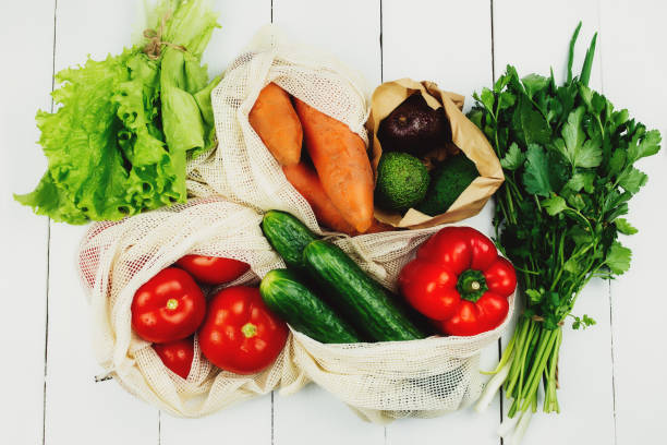 istock Fresh vegetables in eco bags on white table 1292583814