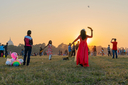 Kolkata, West Bengal, India - 25th December 2017 : Indian girl playing badminton at Kolkata maidan during sunset, Christmas celebration. It is a place for many civilians to spend in winter afternoon.