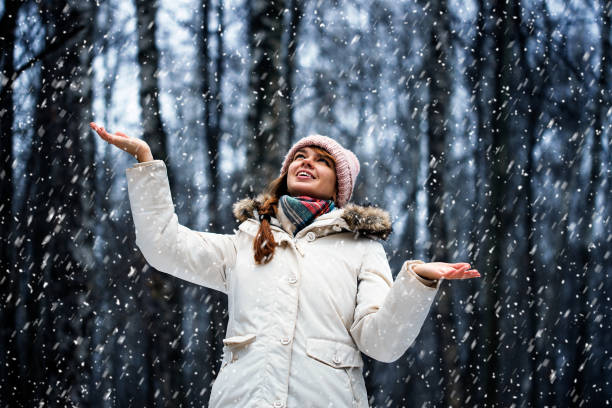 istock Woman and flying snowflakes. 1292588803