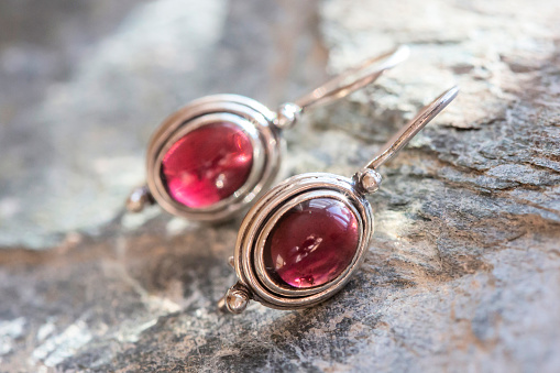 pair of sterling silver garnet mineral earrings on natural background