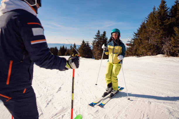 istock Smiling young woman having first ski lessons at the mountain 1292592375