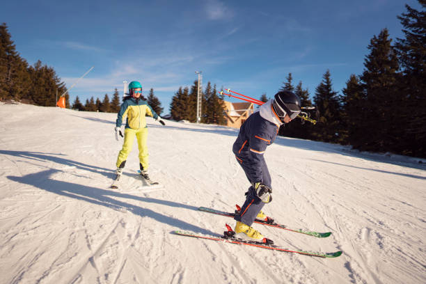 istock Ski instructor teaching female skier how to make turns 1292592399