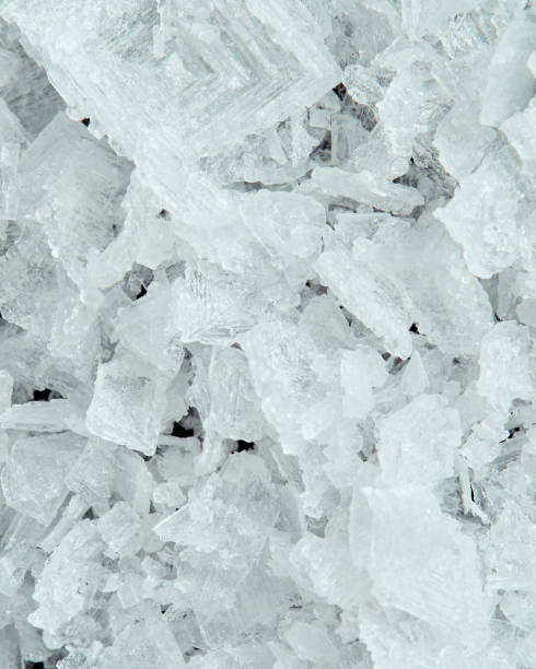 istock Sea salt crystals on a black background, super macro image. 1292595098