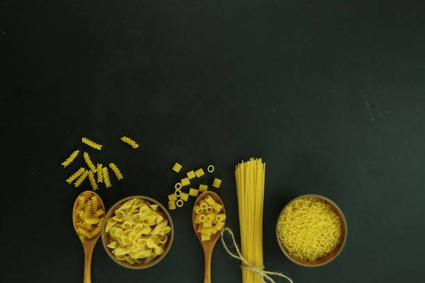 ingredients for homemade pasta. Food background: macaroni, spagetti, egg, flour ingredients for homemade pasta. Food background: macaroni, spagetti, egg, flour carbohydrate food type photos stock pictures, royalty-free photos & images