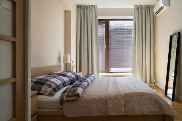 istock Morning sun in beige bedroom 1292595166