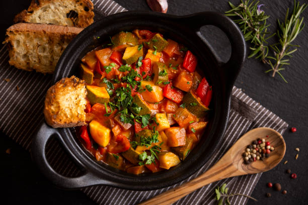 istock Cooked various chopped vegetables with herbs in a black cooking pot 1292597287