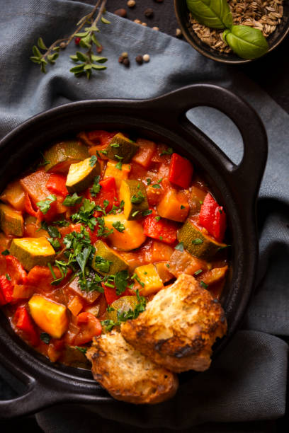istock Cooked various chopped vegetables with herbs in a black cooking pot 1292597318