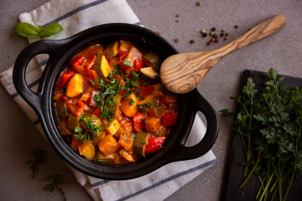 istock Cooked various chopped vegetables with herbs in a black cooking pot 1292597381