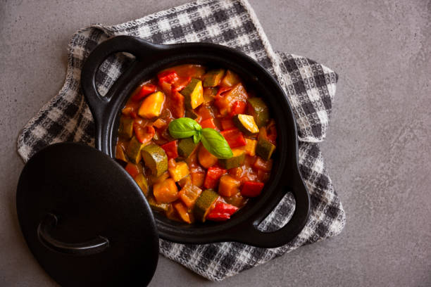 istock Cooked various chopped vegetables with herbs in a black cooking pot 1292597428