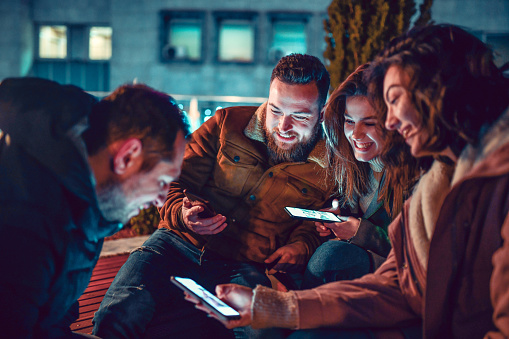 Friends Spending Time With Smartphones Outside