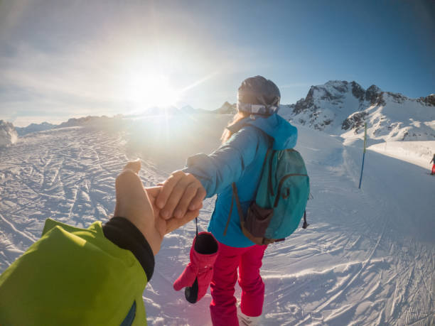 istock Couple holding hands on ski slope 1292597480