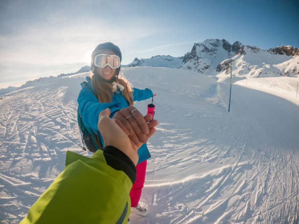 istock Couple holding hands on ski slope 1292597527