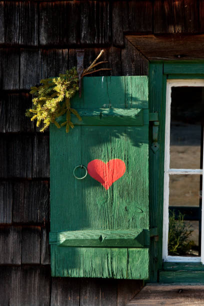 red heart painted on wooden shutter