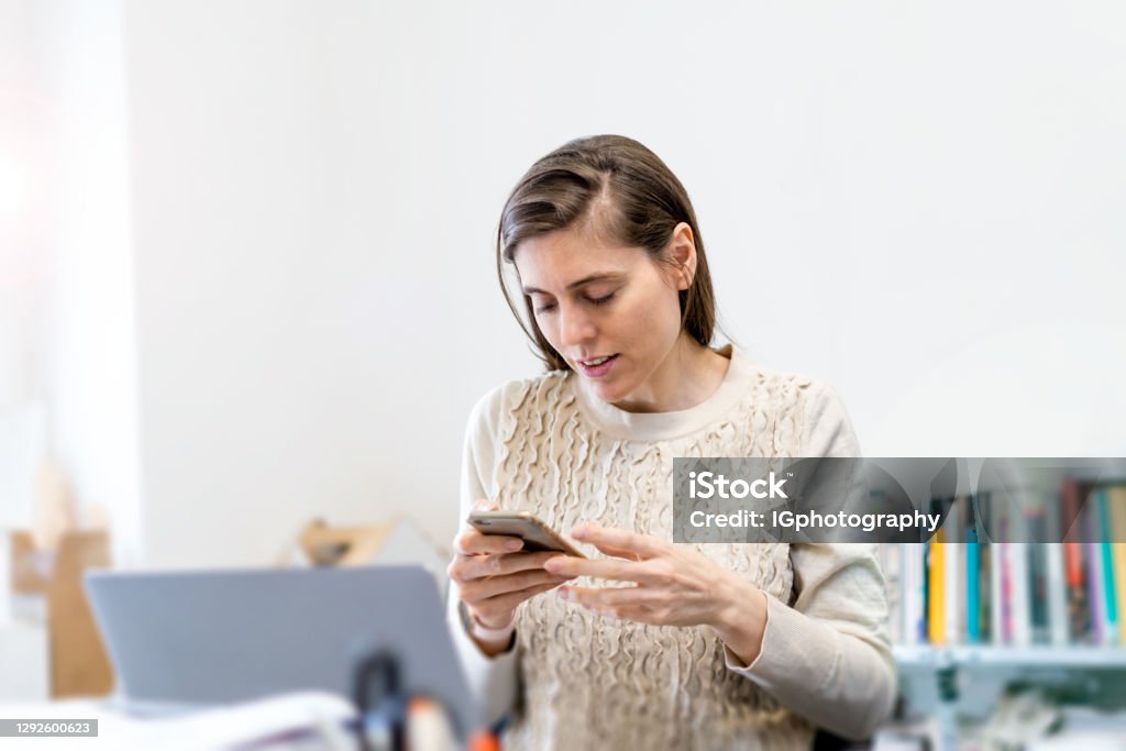 Texting Office Coworker Text Messaging While Working At The Office Stock Photo ...