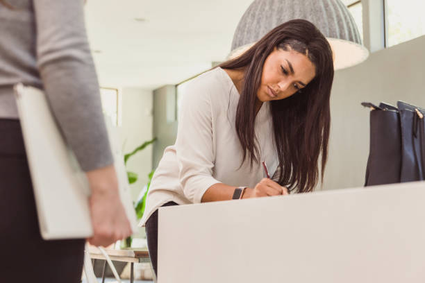 istock New homeowner signs paperwork with Real Estate Agent 1292600764