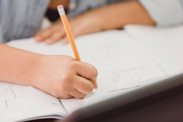 istock Unrecognizable schoolgirl works on homework assignment 1292600814