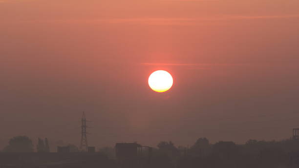 istock Sunrise at city with high-voltage power transmission line timelapse 1292600836