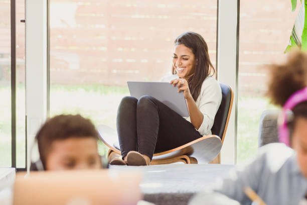 istock Children do schoolwork; mom enjoys social media 1292600868
