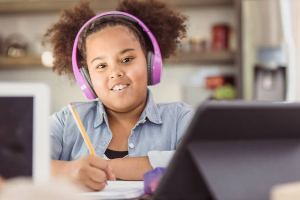 Cute, confident elementary age girl works on homeschool work