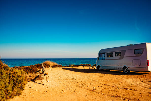 istock Camper car on beach, camping on nature 1292600885