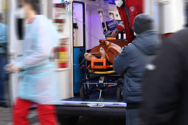 istock Health care workers transferring covid-19 patient 1292601116