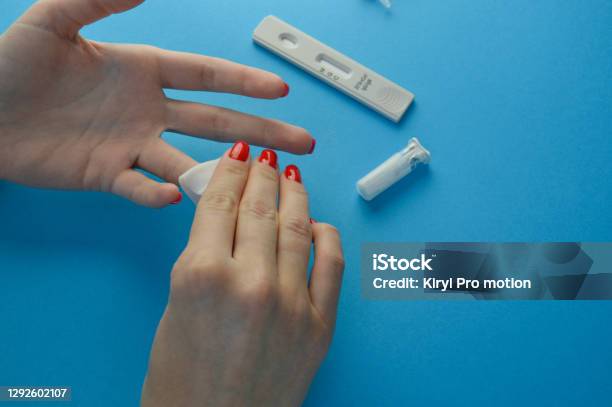 Hands Of A Nurse With Individual Protection Equipment And Patient In The Process Of Blood Collection To Make A Rapid Test For Covid19 In A Hospital Ward With Sanitary Elements Stock Photo - Download Image Now