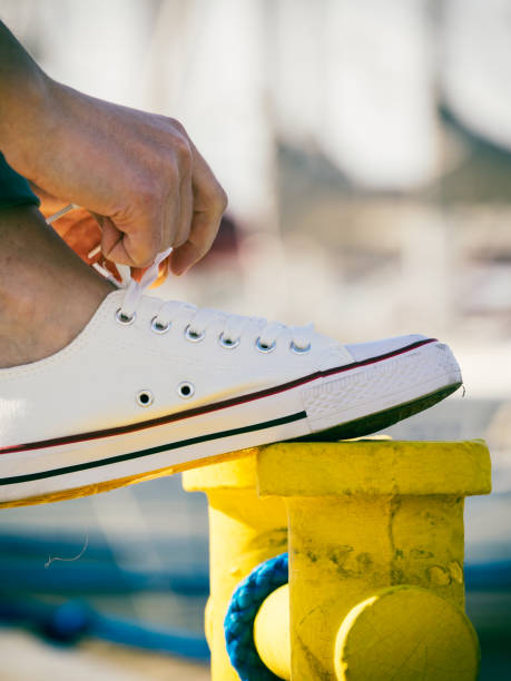 istock Woman tying shoes, white sneakers 1292602314