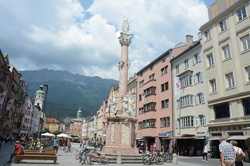 People walking in the surrounding of St. Anne's Column and stores in downtown Innsbruck, Austria