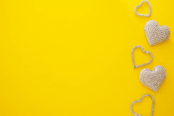 Abstract Valentine's Day mock u, yellow background with sparkling hearts.