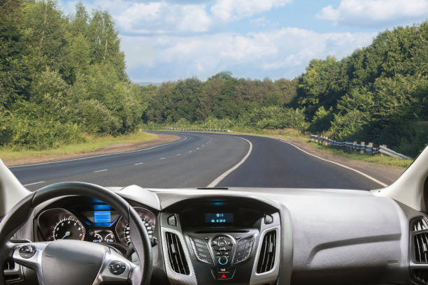 istock View through the windshield of a car on a country highway 1292603115